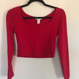 A red cropped long sleeved shirt
